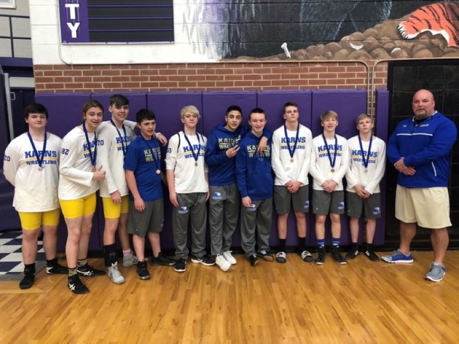 The wrestling team poses with their medals after a recent competition