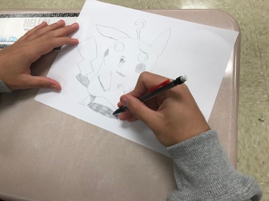 A student practices their newly-gained drawing skills during a break between classes.