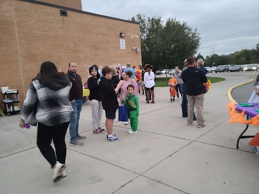 Families visit booths run by various KHS clubs during Ghoul at the School