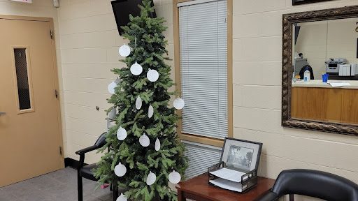 The Angel Tree is located in the front office, and anyone may pick up an ornament to contribute.