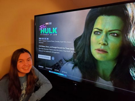 The author poses in front of her television