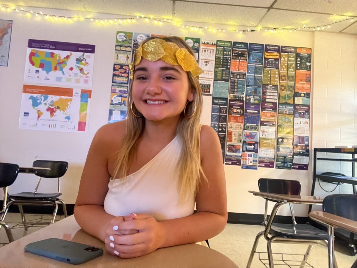 Gracie Moore is all smiles in her gold-trimmed toga on Spirit Day. 