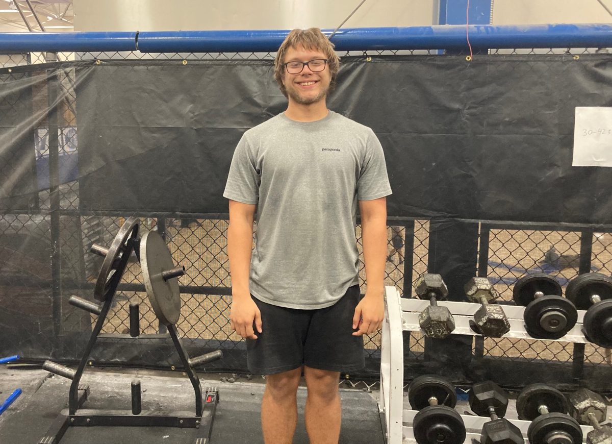 Miles Basalone takes a break in the weight room to smile for the camera