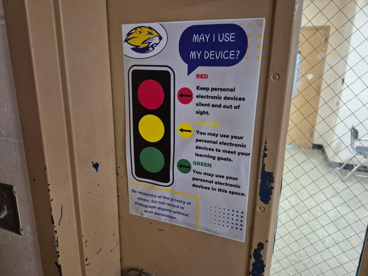 Traffic light posters are showing up in classrooms across the building to help students know when they may use their phones.