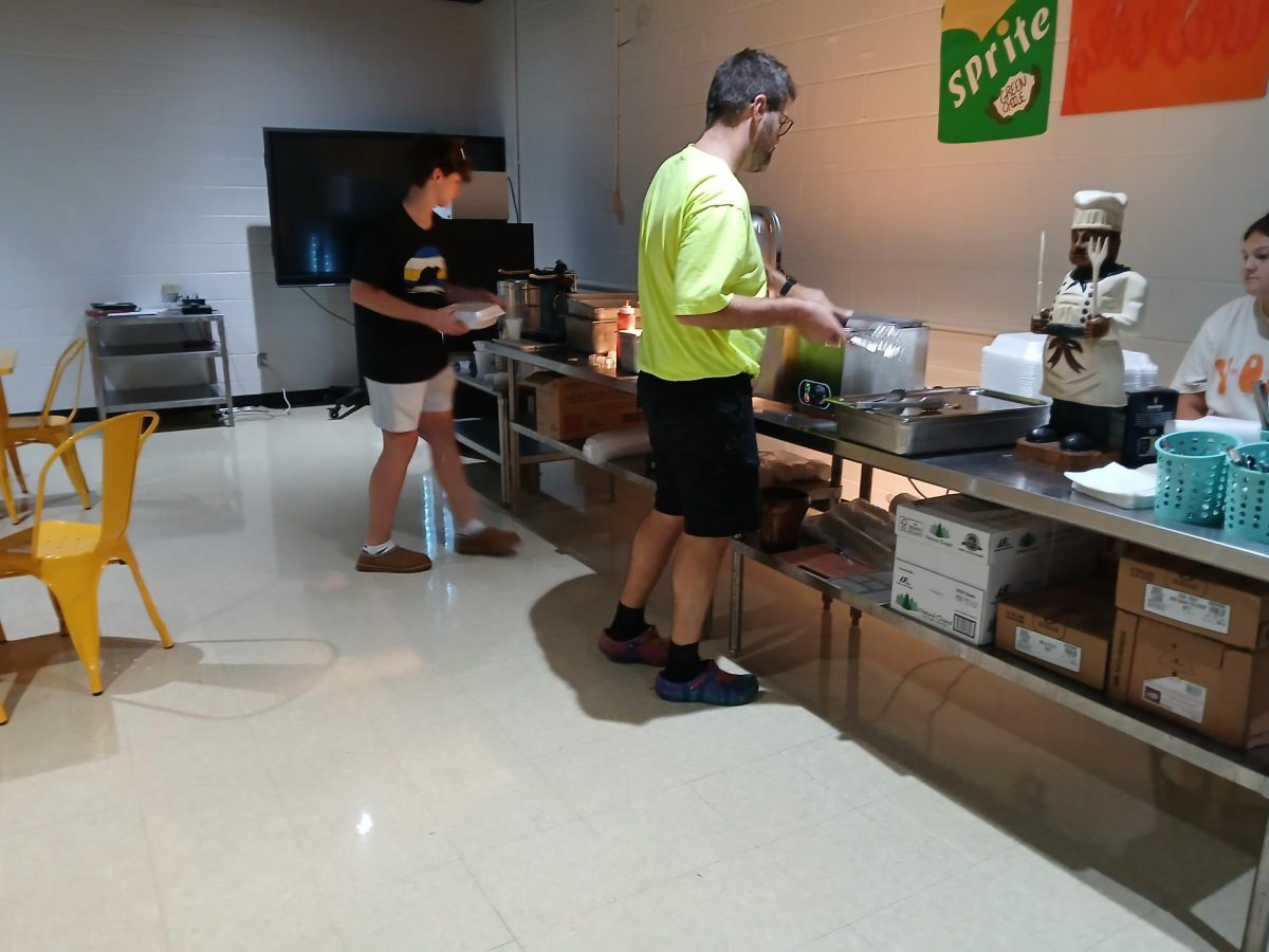 Mr. Neb works with his culinary students to prepare a buffet for the faculty. 