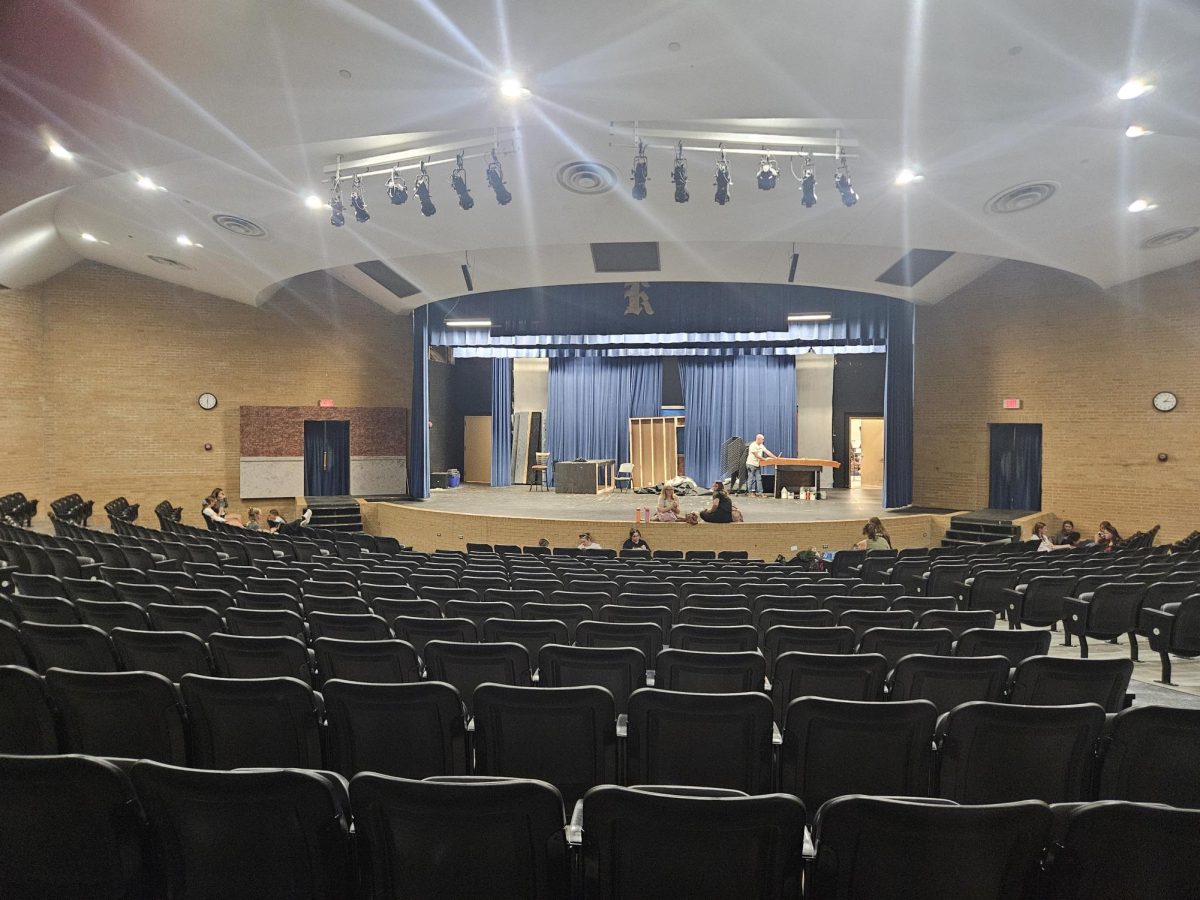 Students work to prepare the auditorium for musical theatre auditions. 