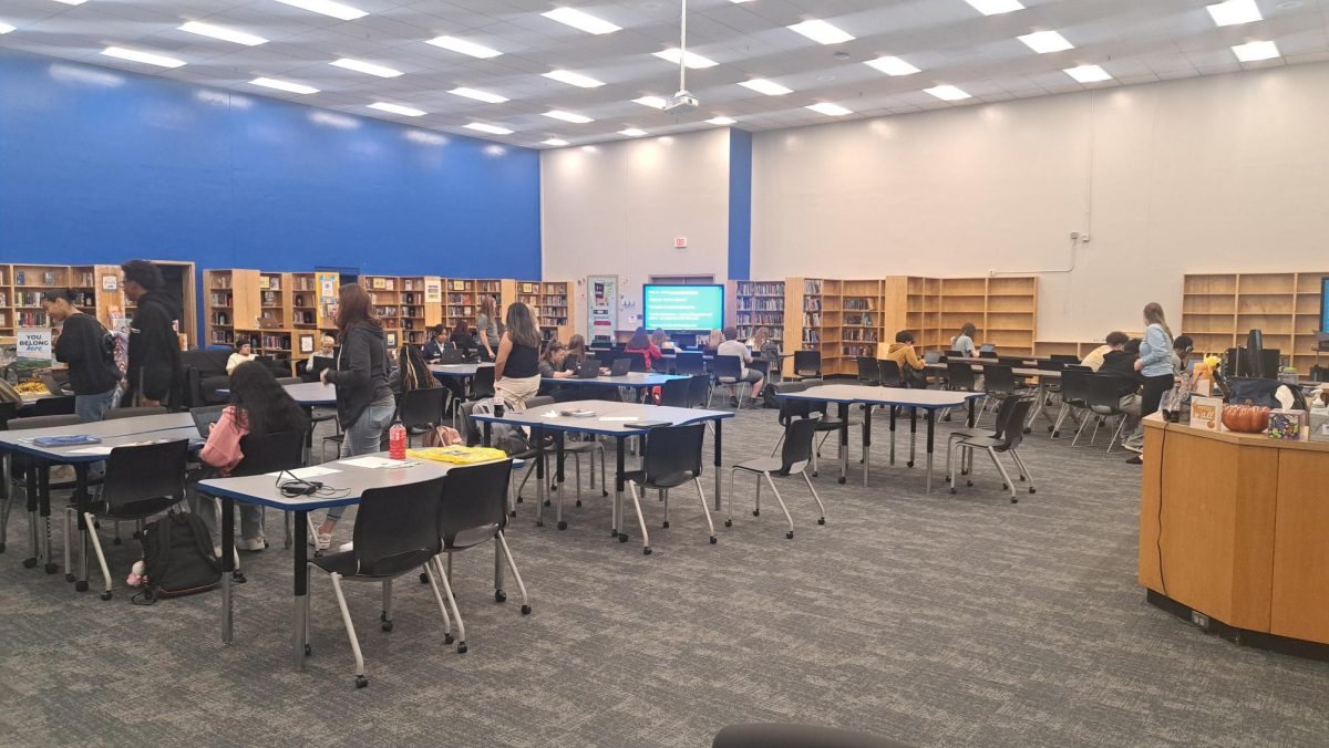 Seniors gather in the library to apply for various colleges during college application week. 