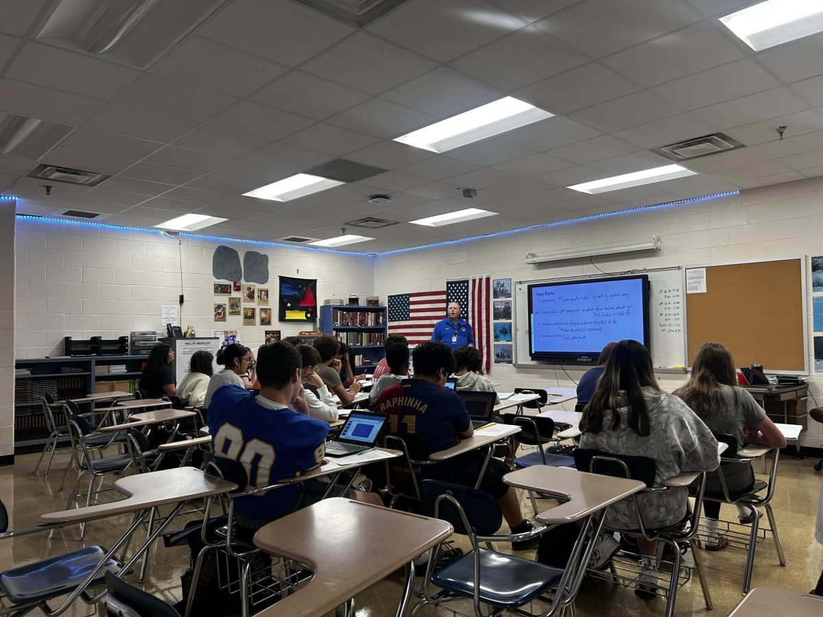 Ninth graders in Coach Hall's class listen to a lecture about history.