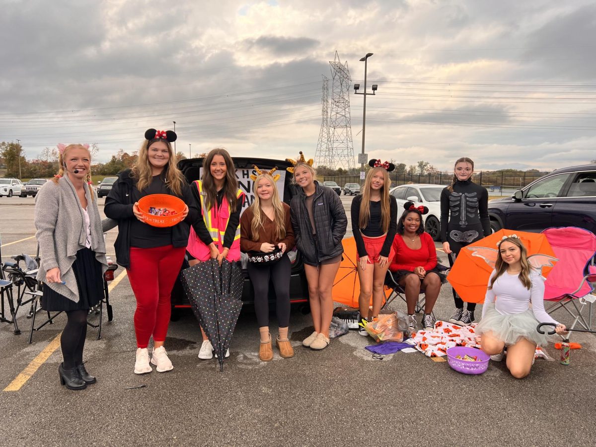 Members of the dance team offer candy to local kids at the 2024 Ghoul at the School.