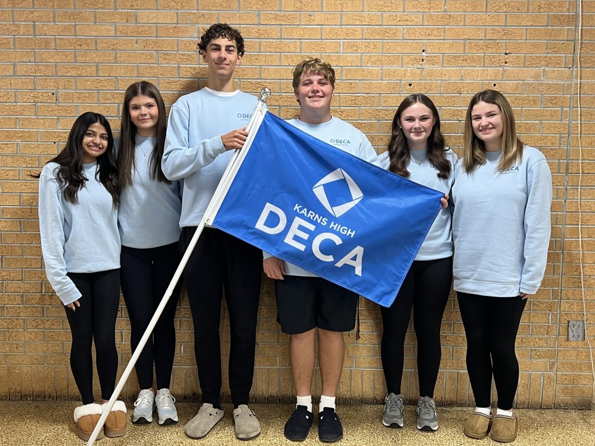 This year's DECA members pose for a photo with their flag.