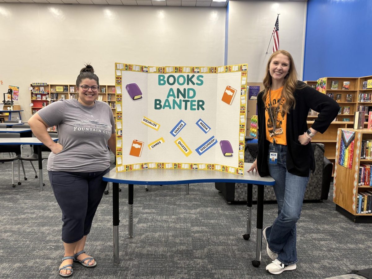 Books and Banter sponsors Ms. Newman and Ms. Reynolds pose with their recruitment poster. 