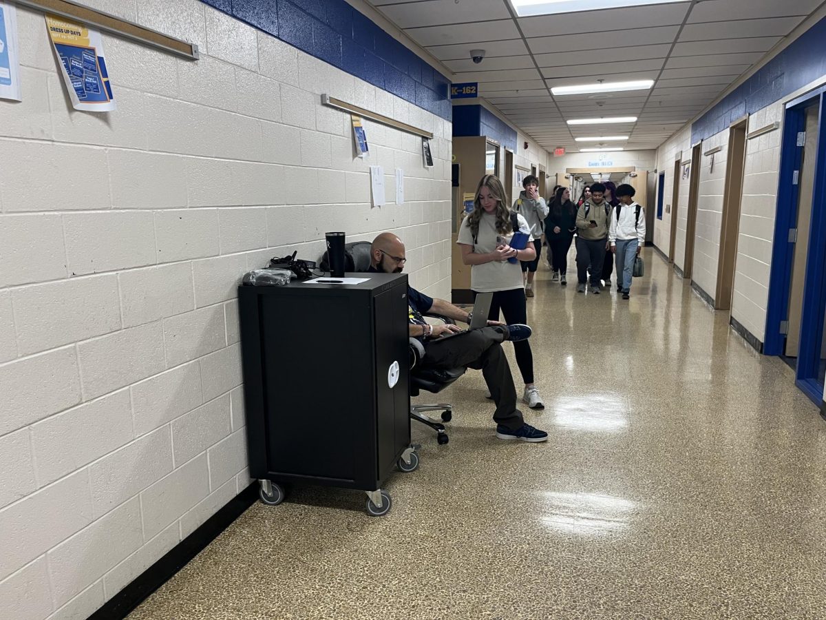 Students check out charged chromebooks as ACT check-in begins. 