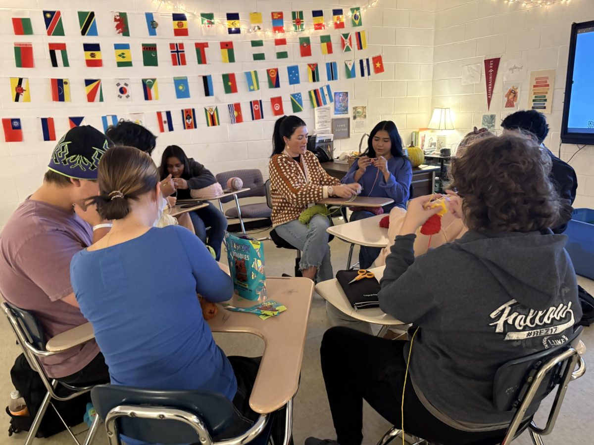 Mrs. Gallaher instructs students in the crochet club on their technique. 